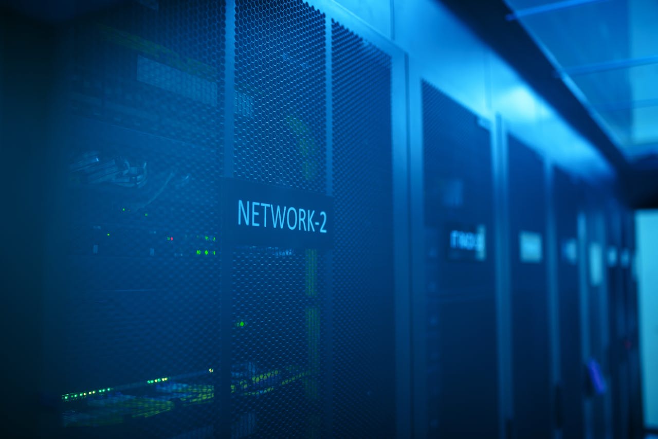 gallery-6 A modern server room featuring network equipment with blue illumination. Ideal for technology themes.