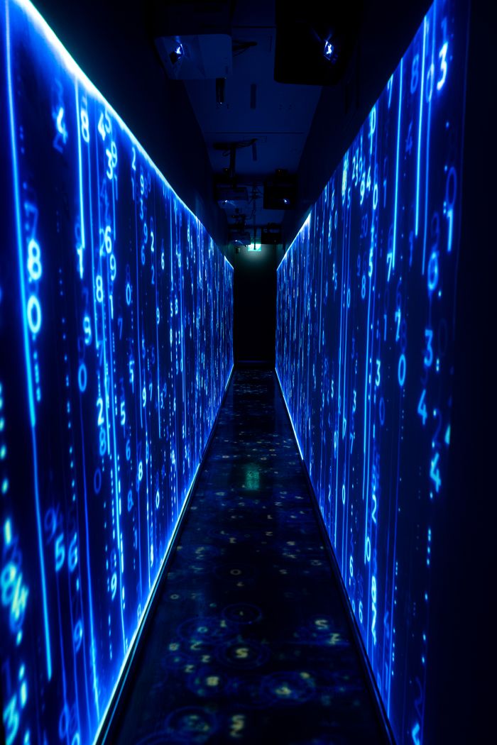 gallery-3 A luminous blue tunnel with digital numbers creating a futuristic, sci-fi ambiance.