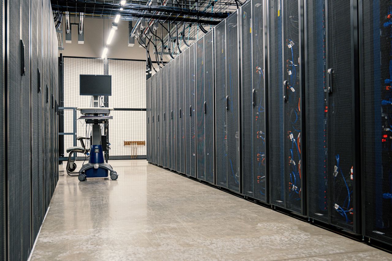 hero-img-01 Steel framework cabinets housing servers networking devices and cables in contemporary equipped data center