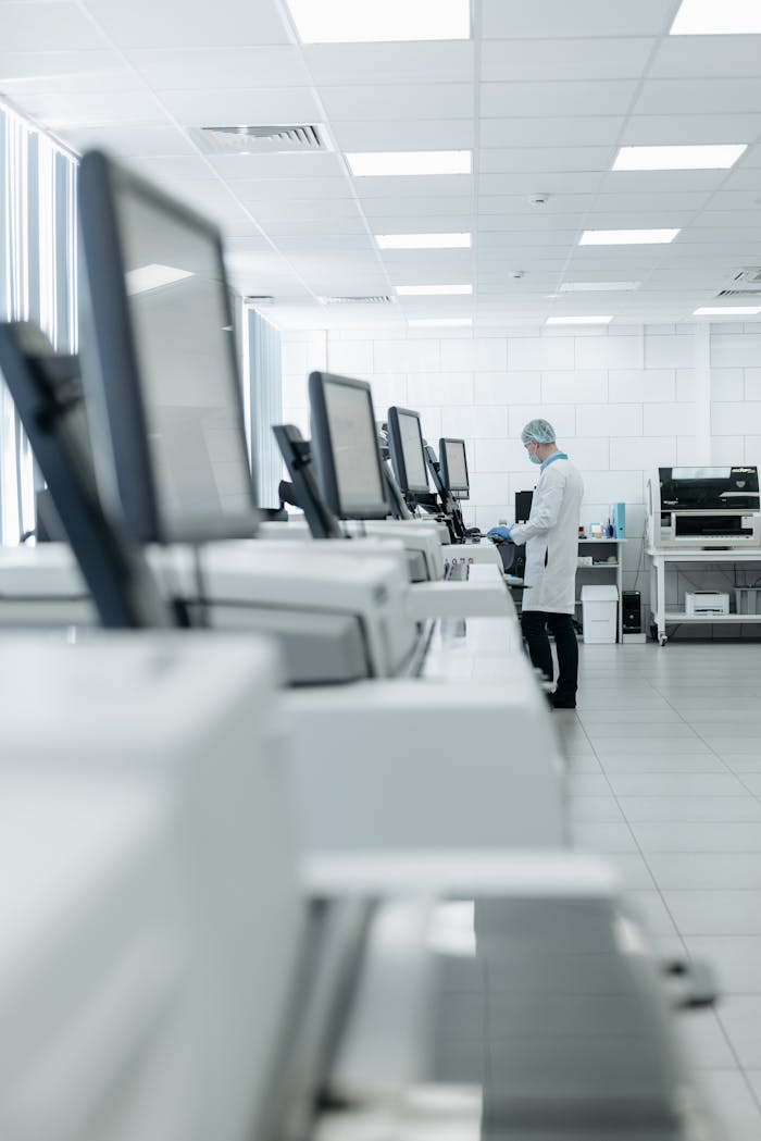 services-img Medical professional in a modern lab using advanced equipment for research.